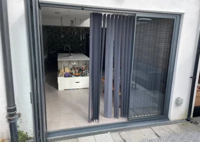 Ultra slim bifolding doors by a patio. UK