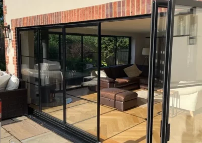 Slim frame external glass pivot patio doors with thin, narrow black frames