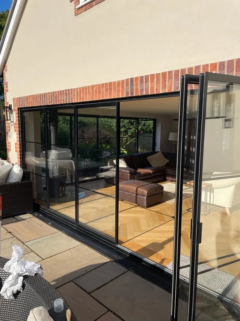 Slim frame external glass pivot patio doors with thin, narrow black frames