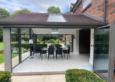 Modern sliding glass doors with panoramic views over a garden, UK