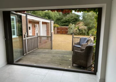 Fully open glass curtains overlooking a garden