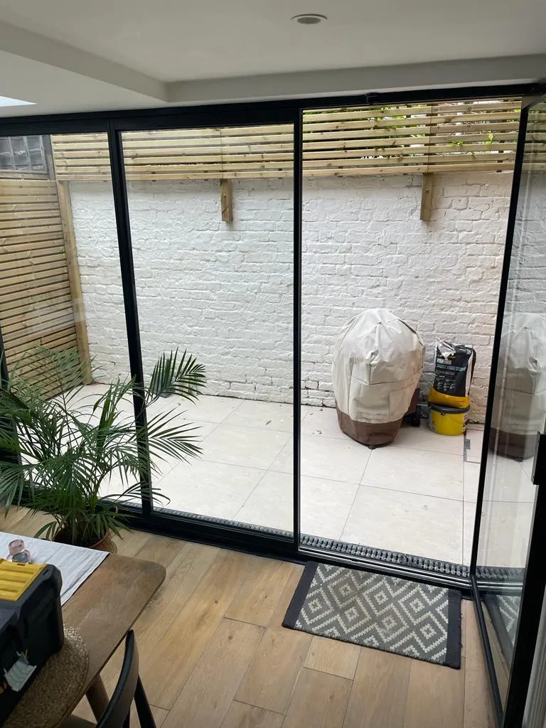 Ultra thin bifolding doors forming a glass wall