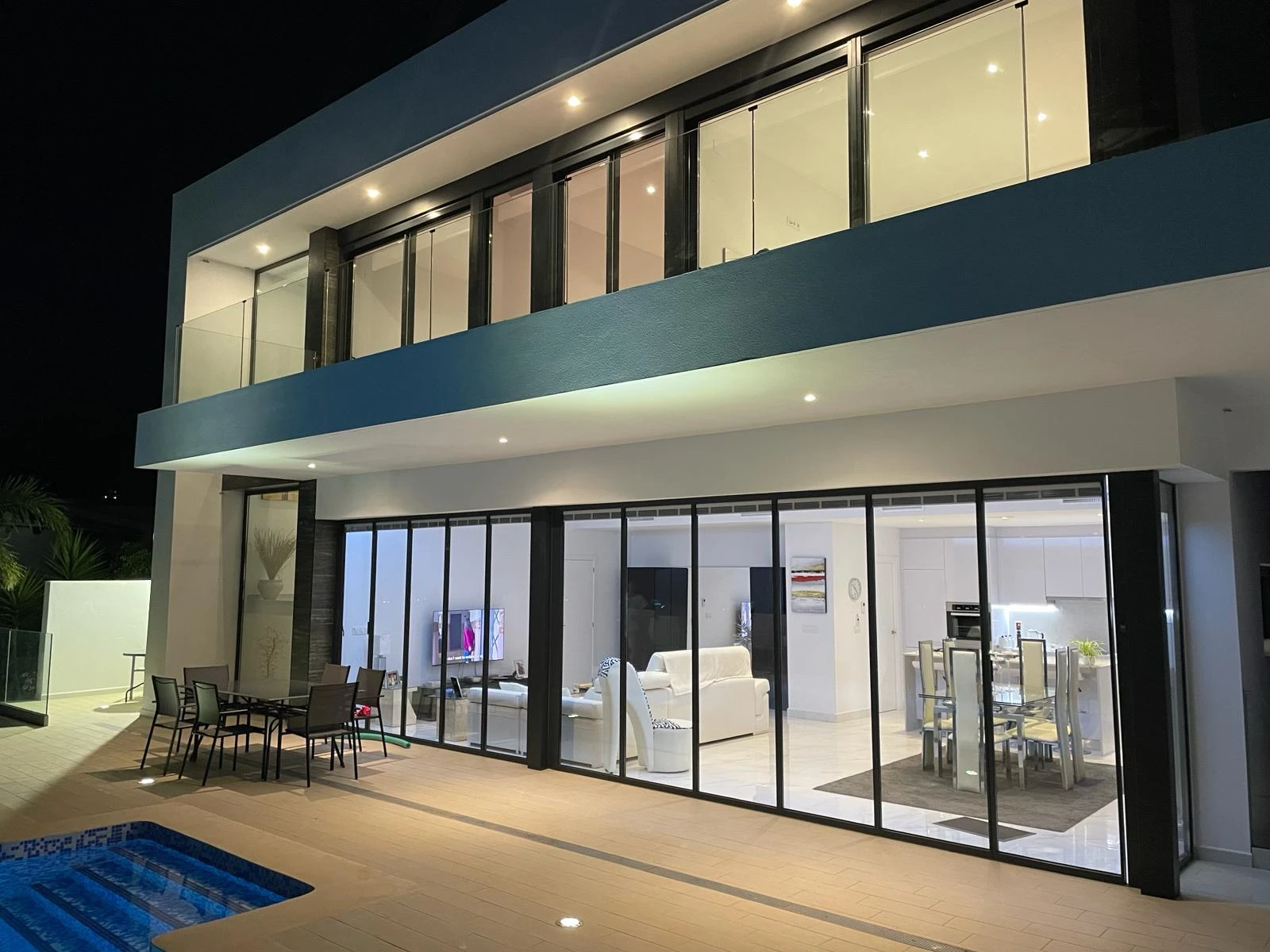 slimline bifold doors doors installation by a pool at night