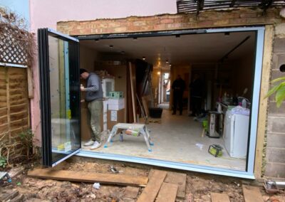 Slimline concertina doors by a patio. Brick home, UK