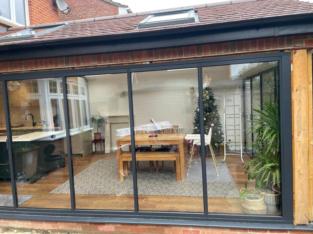 Minimal sliding doors by a patio. Brick home, UK