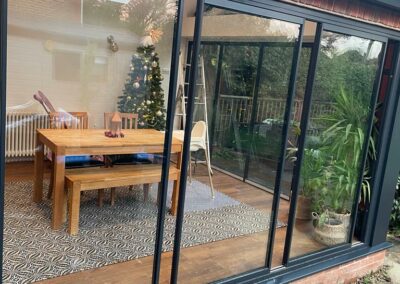 Slimline sliding doors by a patio. Brick home, UK