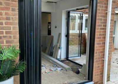 Ultra slim sliding doors by a patio. Brick home, UK