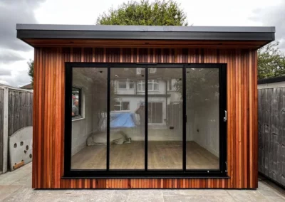 Ultra slim sliding glass doors by a patio. Wooden home, UK