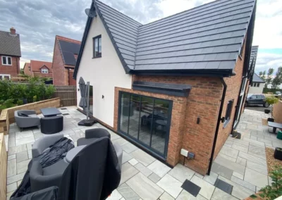 Thin frame sliding doors by a patio. Brick home, UK