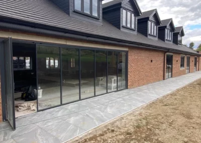 Bifold patio doors flush with floor. Brick home, UK