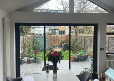 Minimal glass doors installed in a kitchen extension in the UK. Black minimal aluminium frames.