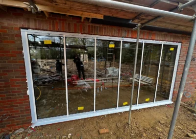 White ultra slim bifold doors being installed