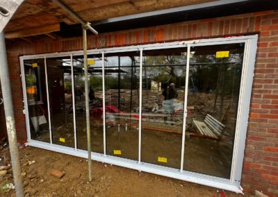 Ultra slim bifolding glass doors being installed