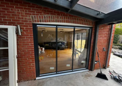 Ultra slim bifold patio doors, brick home