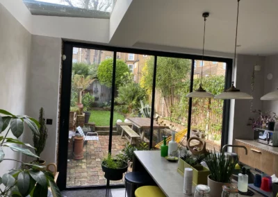 Garden views from modern UK dining area with ultra slim bifold doors