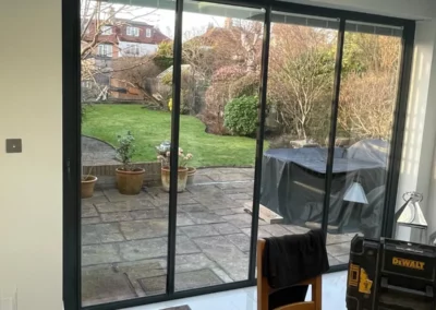 Garden views from dining area with ultra slim bifold doors by Vision Glass Doors