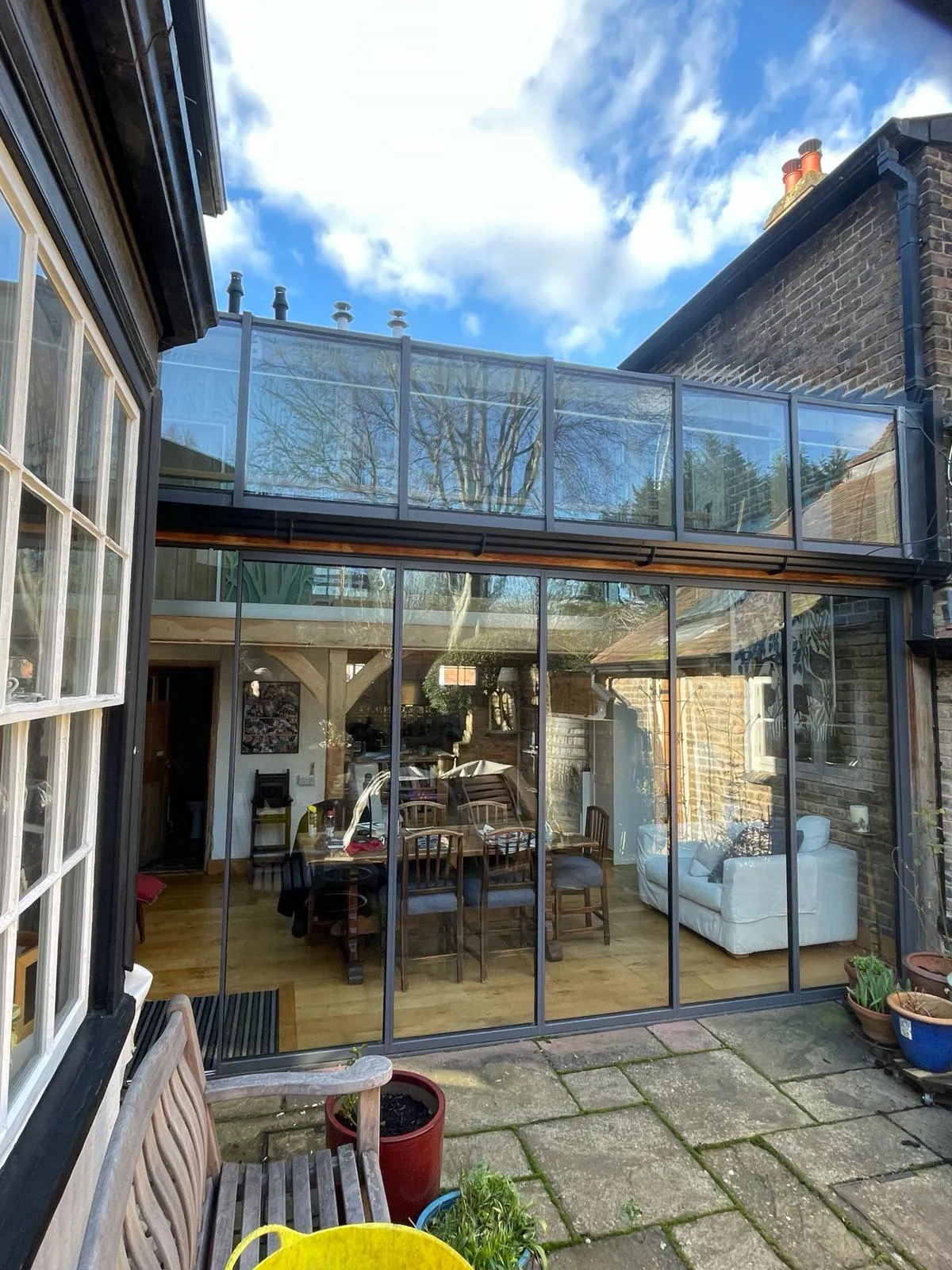 Folding sliding glass doors with slim frames, great views and energy efficiency, installed in a UK home by a patio