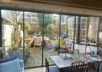 Slimline low profile bifold doors letting in lots of light and giving panoramic garden views from dining area