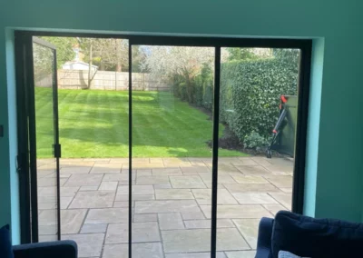 Frameless glass doors, patio and garden view. External