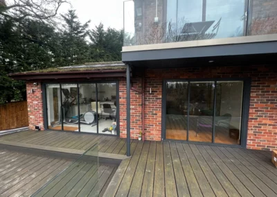 Ultra slim bifolding doors by a patio. Brick home, UK