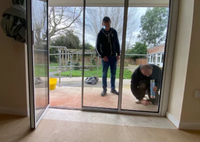 Frameless bi fold patio doors being installed by our team