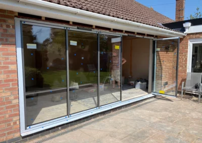 frameless glass patio doors partially open