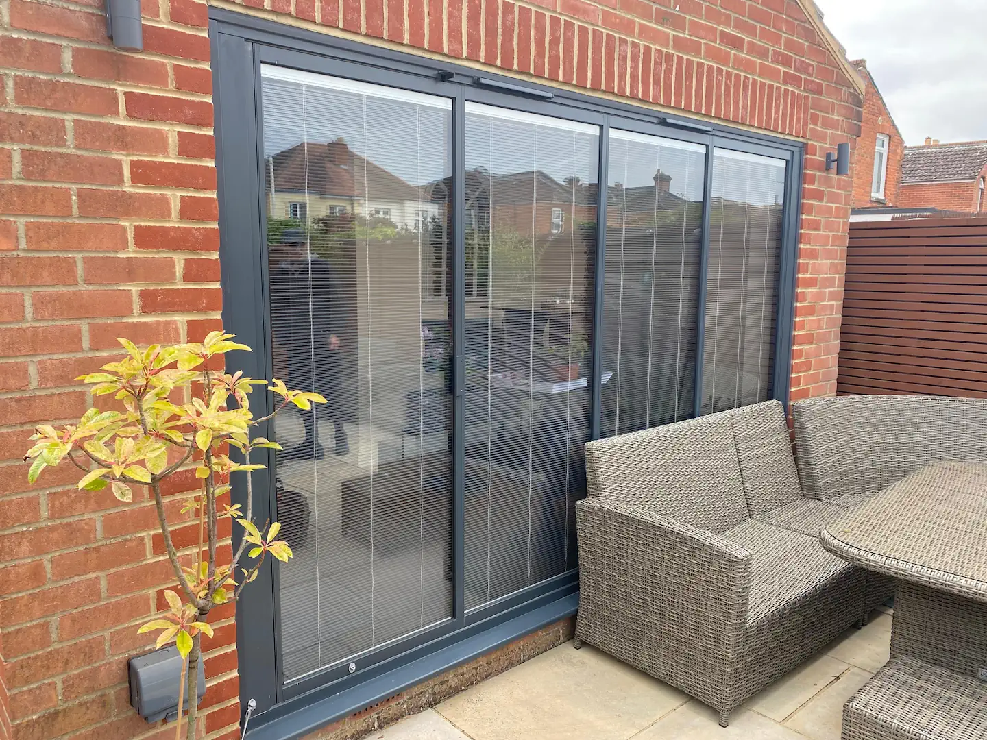 grey bifold doors with integral blinds