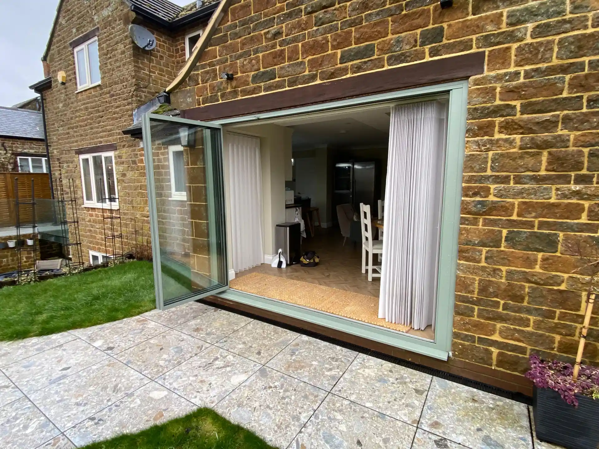 open sage green folding doors