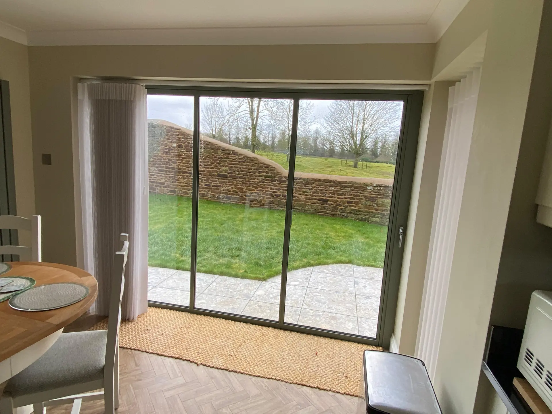 sage green bifold doors looking out